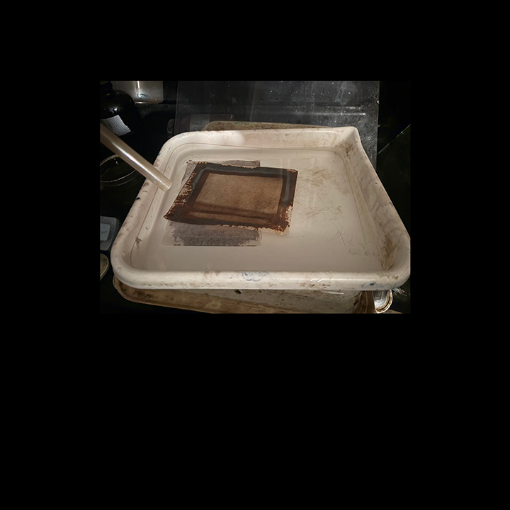 prints being washed in running water, and later fixed in plain hypo.